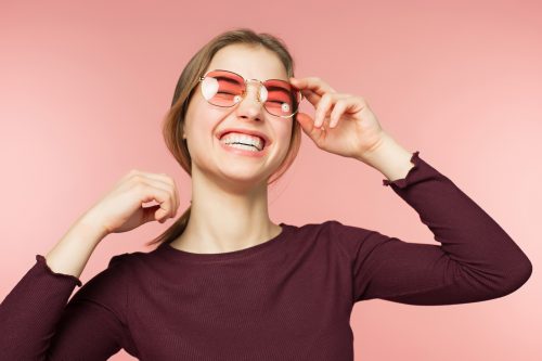 lady smiling wearing Invisalign on holiday